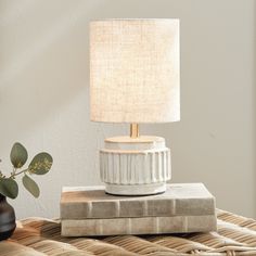 a table lamp sitting on top of a stack of books