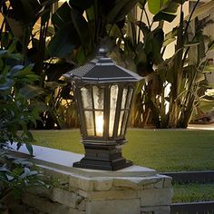 an outdoor lamp is lit up in the evening