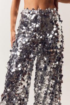 Sequins are always the right answer. Feel glam in our sequin pants, made in high quality sequin fabric, with a stellar wide leg fit, and a textured sequin design. Wear with the matching blazer for a stellar occasion look, perfect for bachelorette nights, engagement parties, and all of your upcoming events, or pair with jeans to dress it down. Disc Sequin Two Piece Wide Leg Pants High Quality Sequin Fabric Unique Large Sequin Design Fierce Wide Leg Silhouette Comforable High Waistline Matching Blazer Sold Separately Model wears a size M (US size 6/UK size 10). Sequin Wide Leg Pants, Sequin Two Piece, Sequin Jeans, Black Tie Party, Going Out Trousers, Large Sequins, Dress With Jean Jacket, Sequin Pants, Engagement Parties