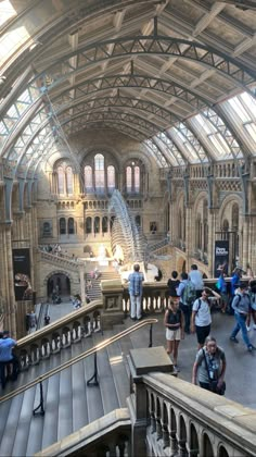 people are walking around inside an old building