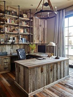 a home office with wooden walls and shelves