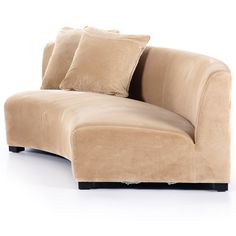 a tan couch with pillows on top of it