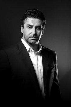 a black and white photo of a man in a suit