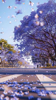 blue flowers are floating in the air near trees and street signs on a sunny day