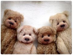 three brown teddy bears sitting next to each other