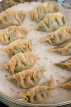 some dumplings are sitting on a white plate