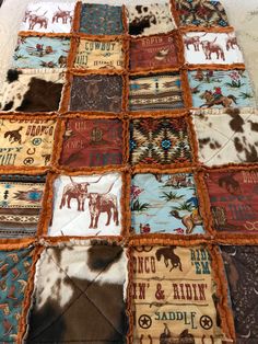 a quilt made to look like an old western blanket with horses and cowhides on it