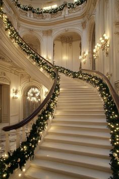 a staircase decorated with christmas garland and lights