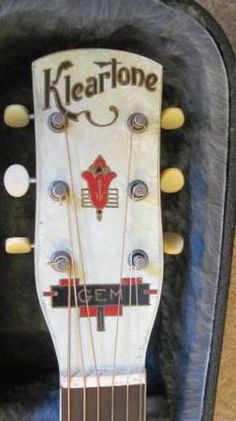 an old guitar case is sitting on the floor with its strings still attached to it