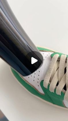 a close up of a tennis shoe with a racket sticking out of it