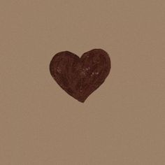 a brown heart shaped object on a beige background