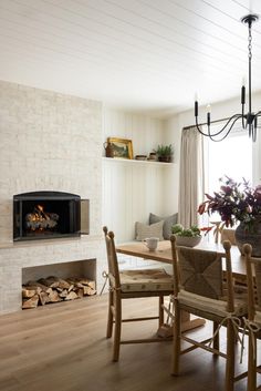 a dining room table with chairs and a fire place