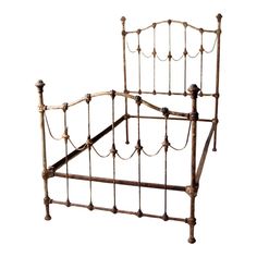 an old iron bed frame with metal posts