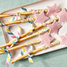 star shaped cookies and sprinkles are arranged on a plate