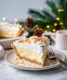 a piece of cake on a plate with a fork and cup next to it in front of a christmas tree