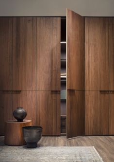 a room with wooden cabinets and a rug on the floor