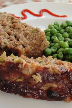 meatloaf, peas and green beans on a white plate