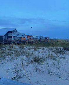 some houses on the beach at dusk with no one in sight or people around them