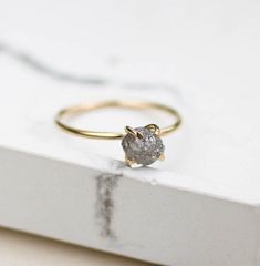 a diamond ring sitting on top of a book