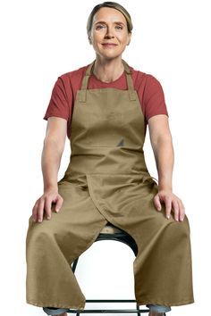 a woman sitting on top of a chair wearing an apron