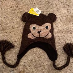 a brown hat with a monkey on it