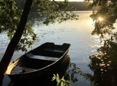 a small boat sitting on top of a lake