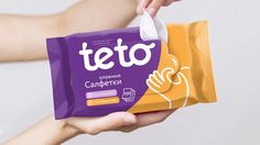 a person holding a bag of teo candy in their left hand and the other hand is reaching for it