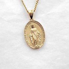 miraculous medal womens necklace pendant M, Médaille miraculeuse made in 14k or 18k real gold this is M 18.5mm. M 18.5mm and L 21.0mm are on our store. the miraculous medal is devotional medal, the original design was executed by Adrien Vachette based on Saint Catherine Laboure visions. our miraculous medal was designed to be more exquisite than the original medal. it has all properties of the original medal, of course. it is the most elaborate miraculous medal. materials 14k real solid gold, 18k real solid gold model wears a 14k 1.2mm 50cm chain. free shipping (fedex) on all orders! 14k womens necklace pendant gold weight (edited 18 Nov 2022) pendant only 2.34g (±3%) with 1.2mm 42cm 4.47g (±3%) with 1.4mm 42cm 5.20g (±3%) with 1.7mm 42cm 6.42g (±3%) 18k womens gold necklace pendant weight Catherine Laboure, Miraculous Medal Necklace, Saint Catherine, Mary Necklace, Virgin Mary Necklace, Catholic Jewelry, Gold Models, Miraculous Medal, Gold Necklace Women