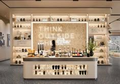 the inside of a store with shelves filled with bottles and other items on display in it