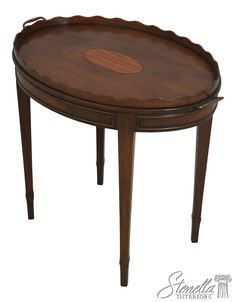 a wooden table with an oval shaped top