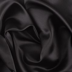 Trying to channel the look of a silk satin without the stress of care and cost? Here we have a collection of glossy polyester satins which are thin in structure and oh-so-smooth. Completely opaque and with no stretch, this material is very similar to a duller finished duchess satin. Easily create a classical and comfortable evening gown, blouse or lining with this chic satin fabric.

Note:This fabric is considered flame retardant under NFPA 701 standards and testing, so you can feel safe while y Duchess Material, Black Satin Fabric, Black Bridal, Dress Gallery, Duchess Satin, Mood Fabrics, Natural Silk, Polyester Satin, Black Solid