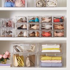 an organized closet with shoes, handbags and purses on the shelves in front of it