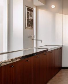 an empty kitchen with wooden cabinets and stainless steel counter tops