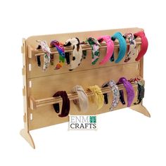 a wooden rack with several pairs of headbands on it