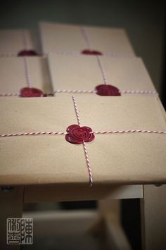 two boxes wrapped in brown paper and tied with twine, sitting on a table