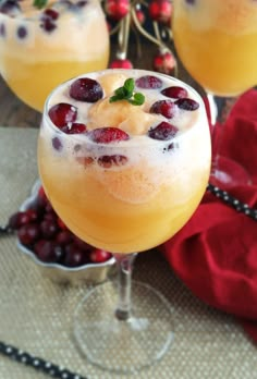 a close up of a drink in a glass with fruit on the rim and garnishes