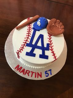 a birthday cake with a baseball, glove and ball on the top that says martin 51