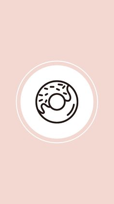 a white plate with a donut on it and a pink wall in the background