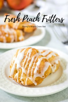 fresh peach fritters with icing on a white plate