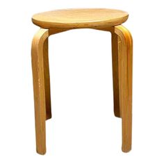 a small wooden stool sitting on top of a white floor