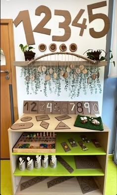 a wooden shelf with numbers and plants on it