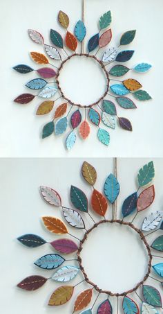 two different colored leaves are hanging on the wall and one is made out of wood