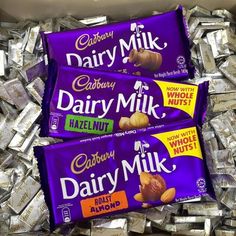 cadbury dairy milk chocolate bars are stacked on top of each other in a box