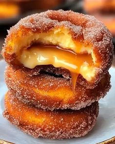 three donuts stacked on top of each other covered in icing and caramel