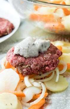 a close up of a plate of food with meat patties and vegetables on it