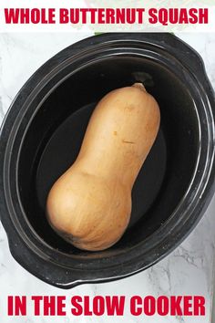 a close up of a food in a crock pot on a marble counter top