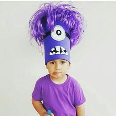 a little boy wearing a purple monster hat