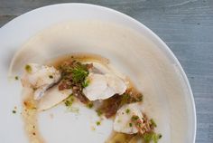 a white plate topped with food on top of a wooden table