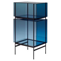 three blue glass boxes stacked on top of each other