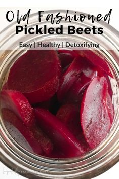 a glass jar filled with sliced beets on top of a white tablecloth and text overlay reads, old fashioned pickled beets easy healthy detoxifying